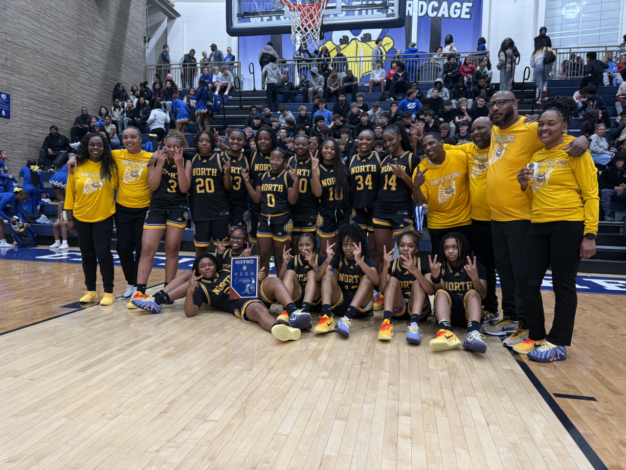 Omaha North girls' basketball celebrates its Metro Holiday Tournament win