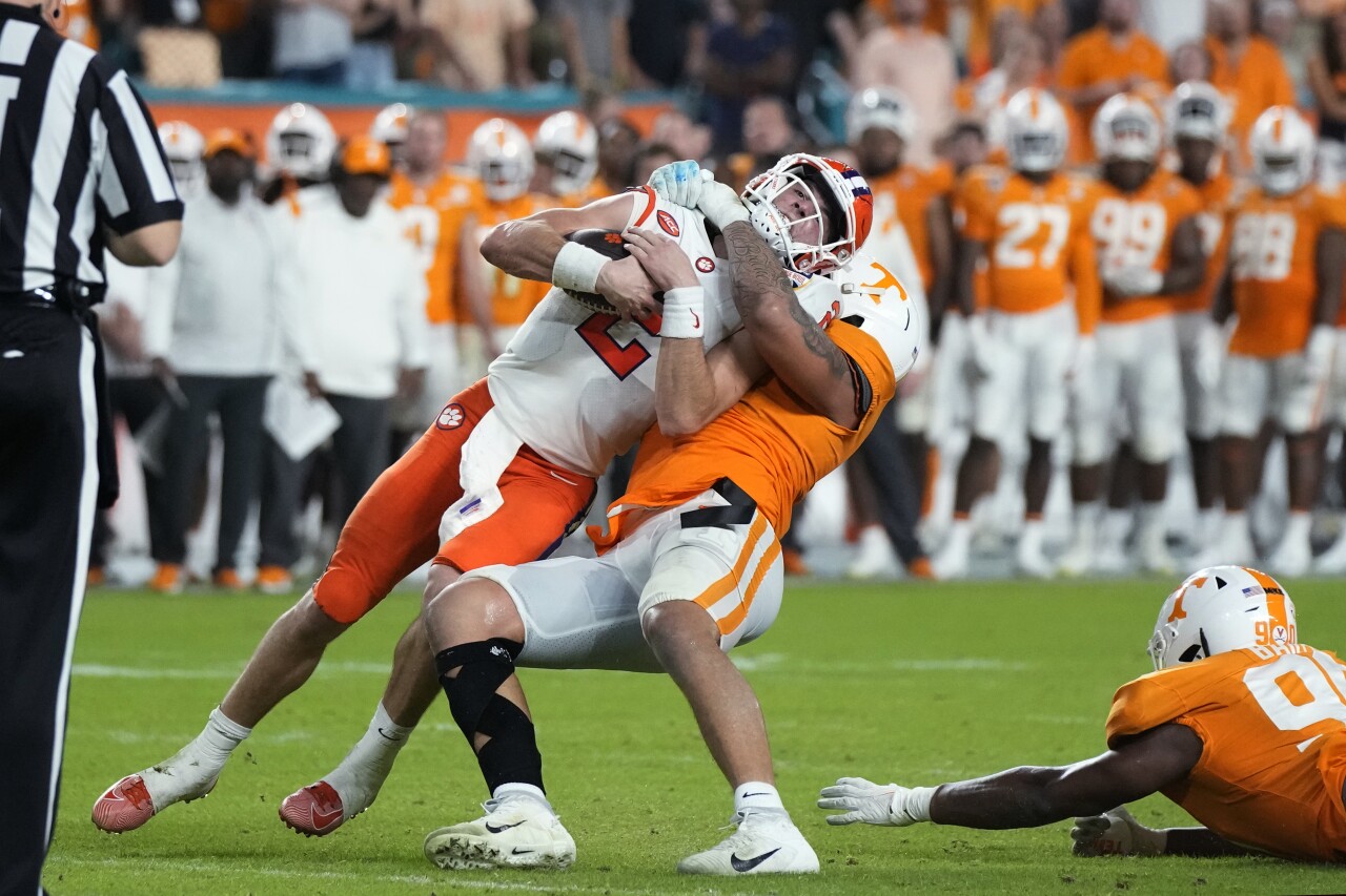 Clemson Tigers QB Cade Klubnik tackled by Tennessee Volunteers defensive lineman Tyler Baron in second quarter of 2022 Orange Bowl