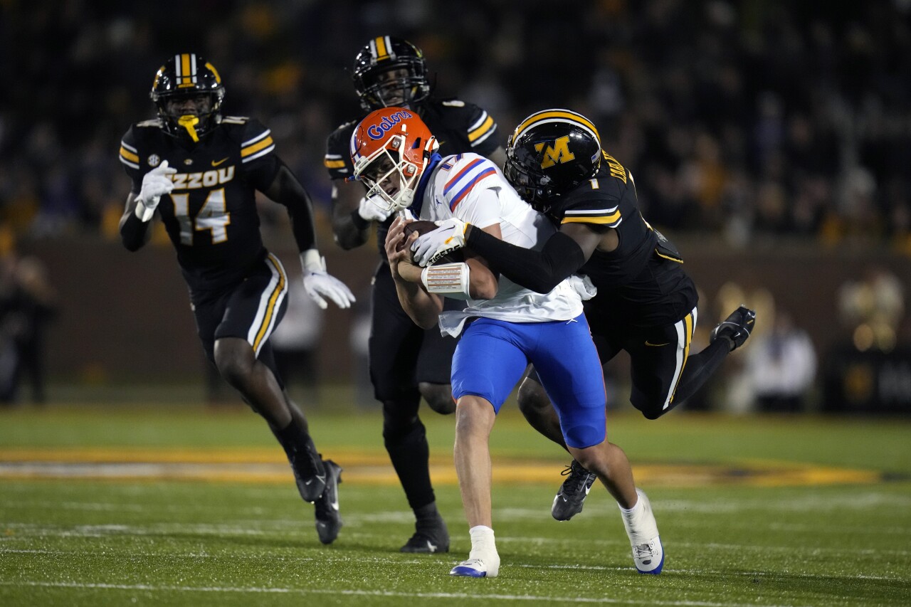 Florida Gators QB Max Browns runs with football as Missouri Tigers safety Jaylon Carlies defends, Nov. 18, 2023