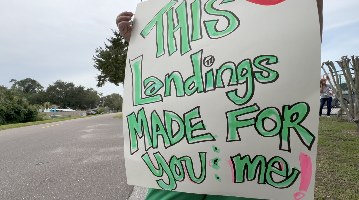 Neighbors rally with signs to protect the space