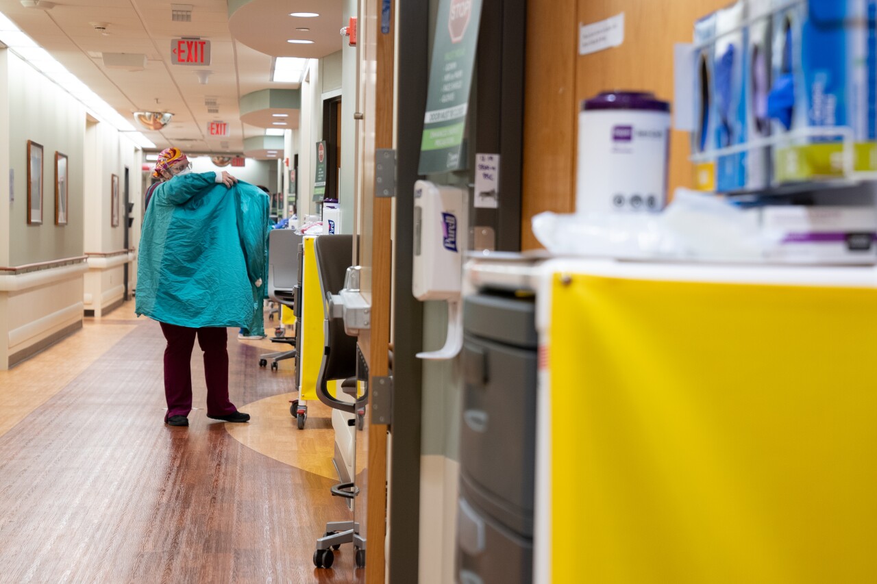 Caregivers dress in protective gear before entering each room.