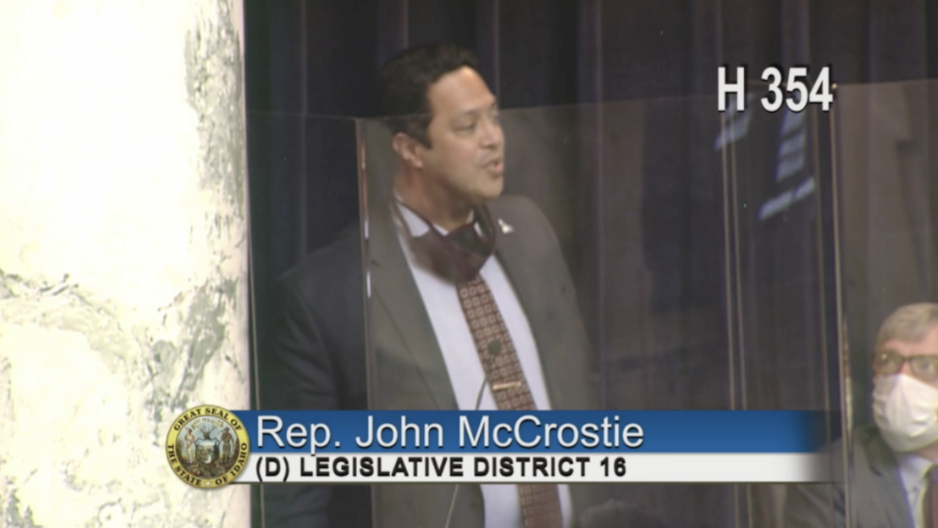 Rep. John McCrostie speaks in front of Idaho House