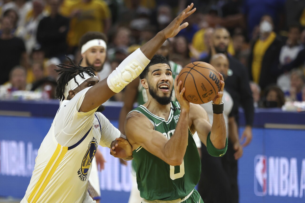Boston Celtics forward Jayson Tatum shoots against Golden State Warriors center Kevon Looney in Game 1 of 2022 NBA Finals