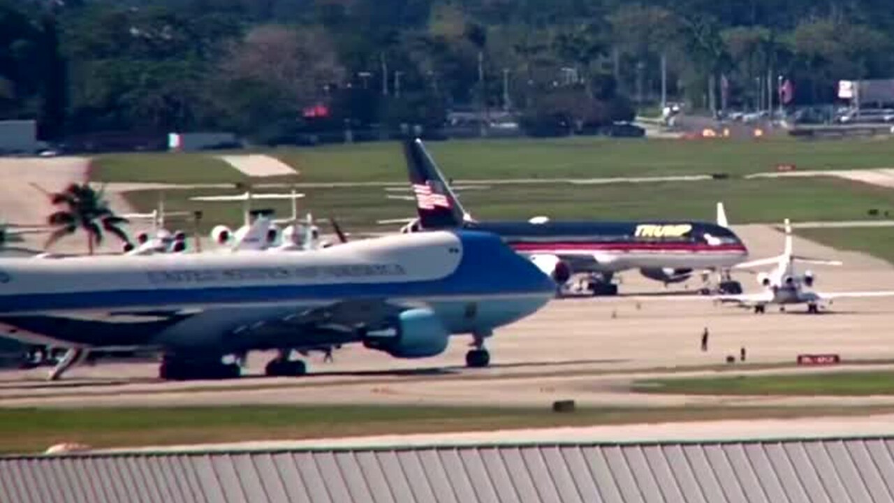 Air Force One sits right next to Donald Trump's private plane at Palm Beach International Airport on Jan. 30, 2024.jpg