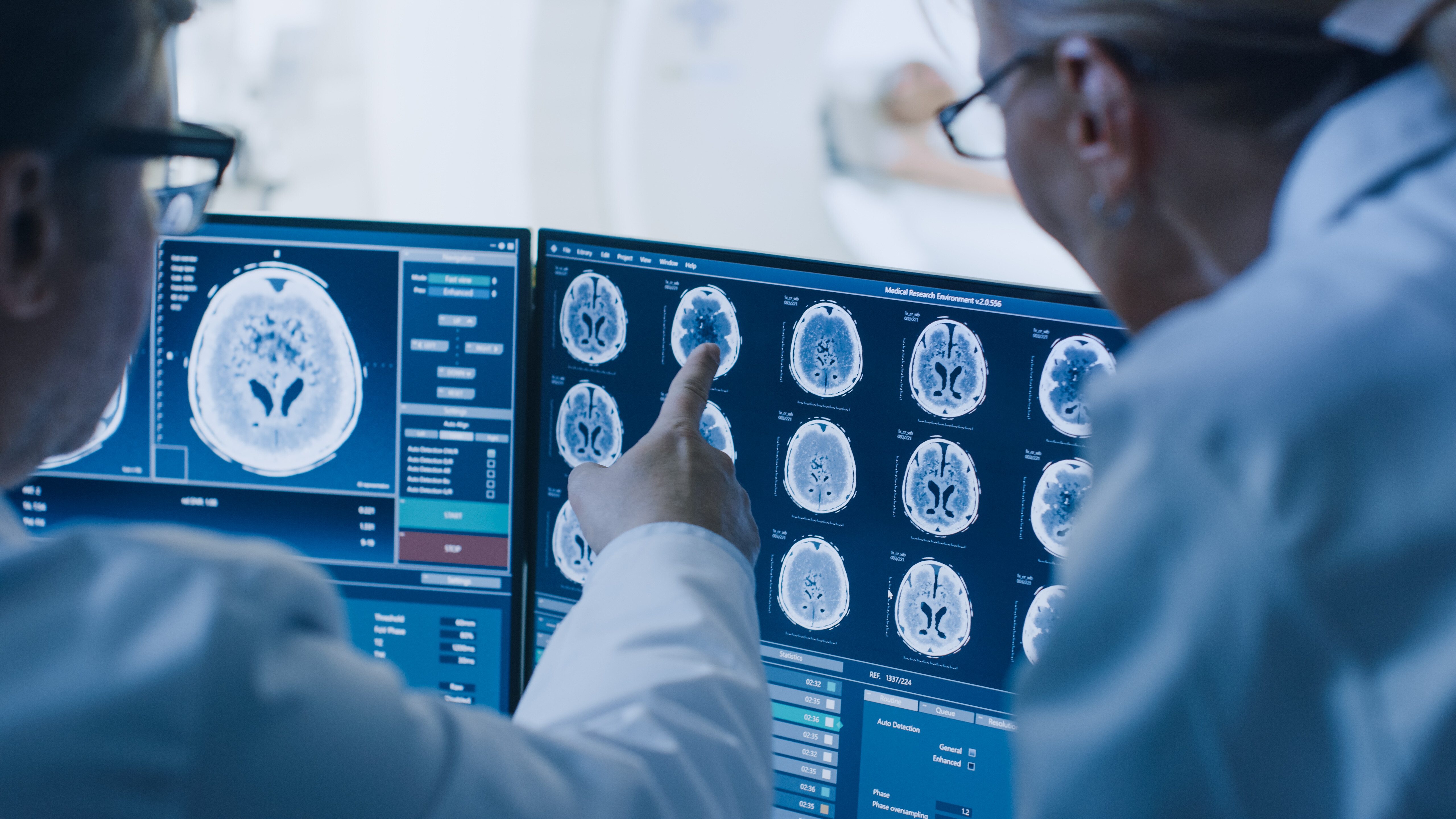 In,Control,Room,Doctor,And,Radiologist,Discuss,Diagnosis,While,Watching