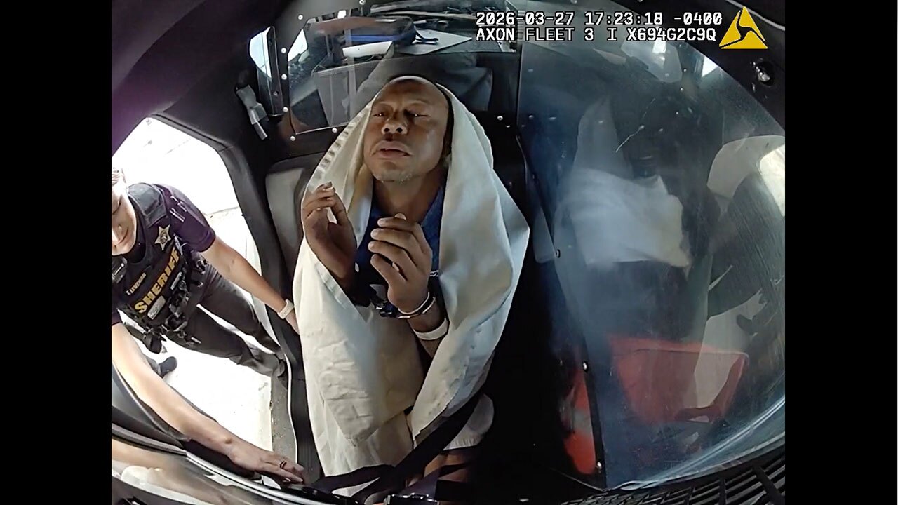 In this image from video provided by the Martin County, Fla., Sheriff's Office, golfer Tiger Woods is strapped into a police vehicle following a car crash in Jupiter Island, Fla., Friday, March 27, 2026.