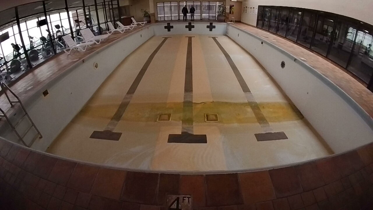 The swimming pool at Reserve Square is empty and closed.