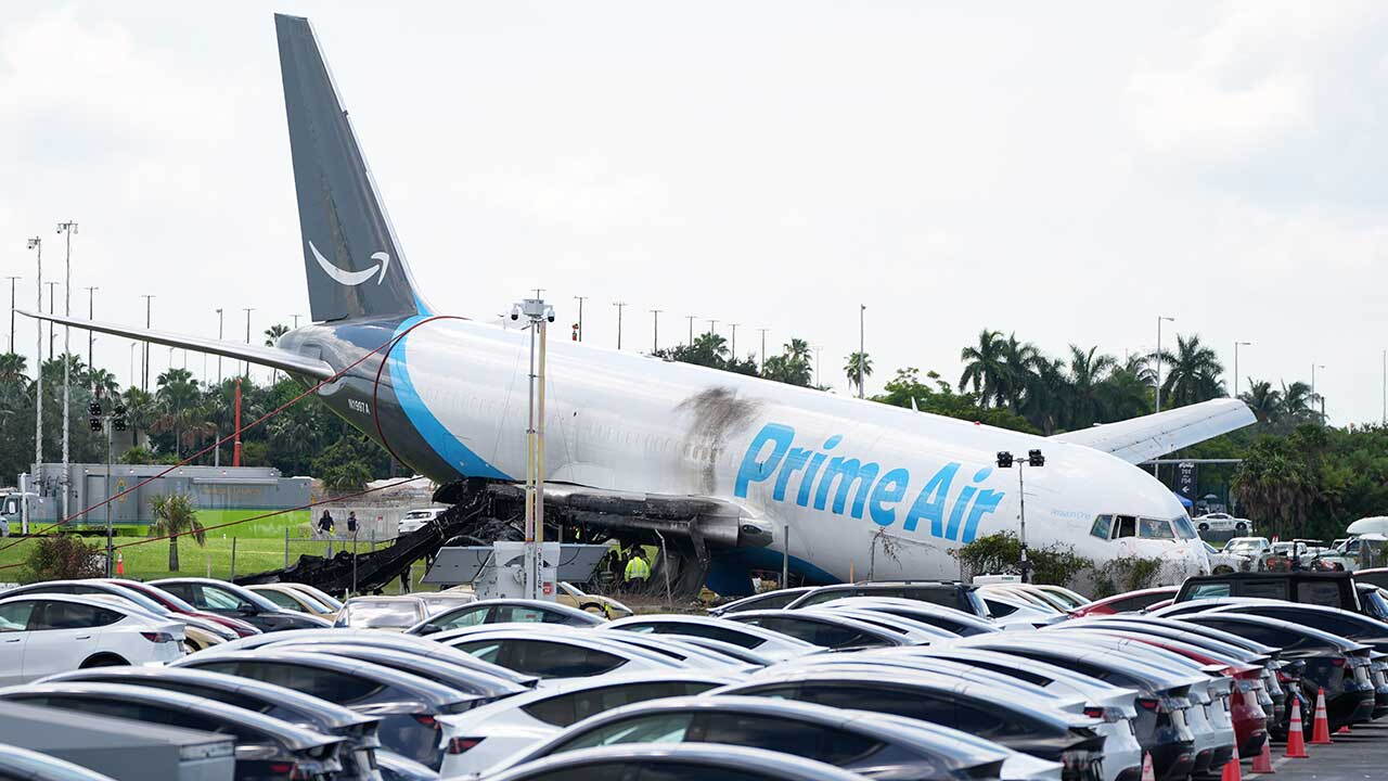 Workers inspect an Amazon cargo plane two days after it overshot a runway at Miami International Airport, Tuesday, Sept. 8, 2026, in Miami. 