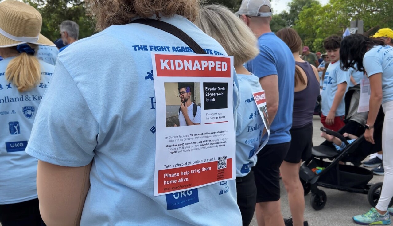 Some people clipped flyers to their backs during walk against antisemitism in Boca Raton. Oct. 22, 2023.jpg