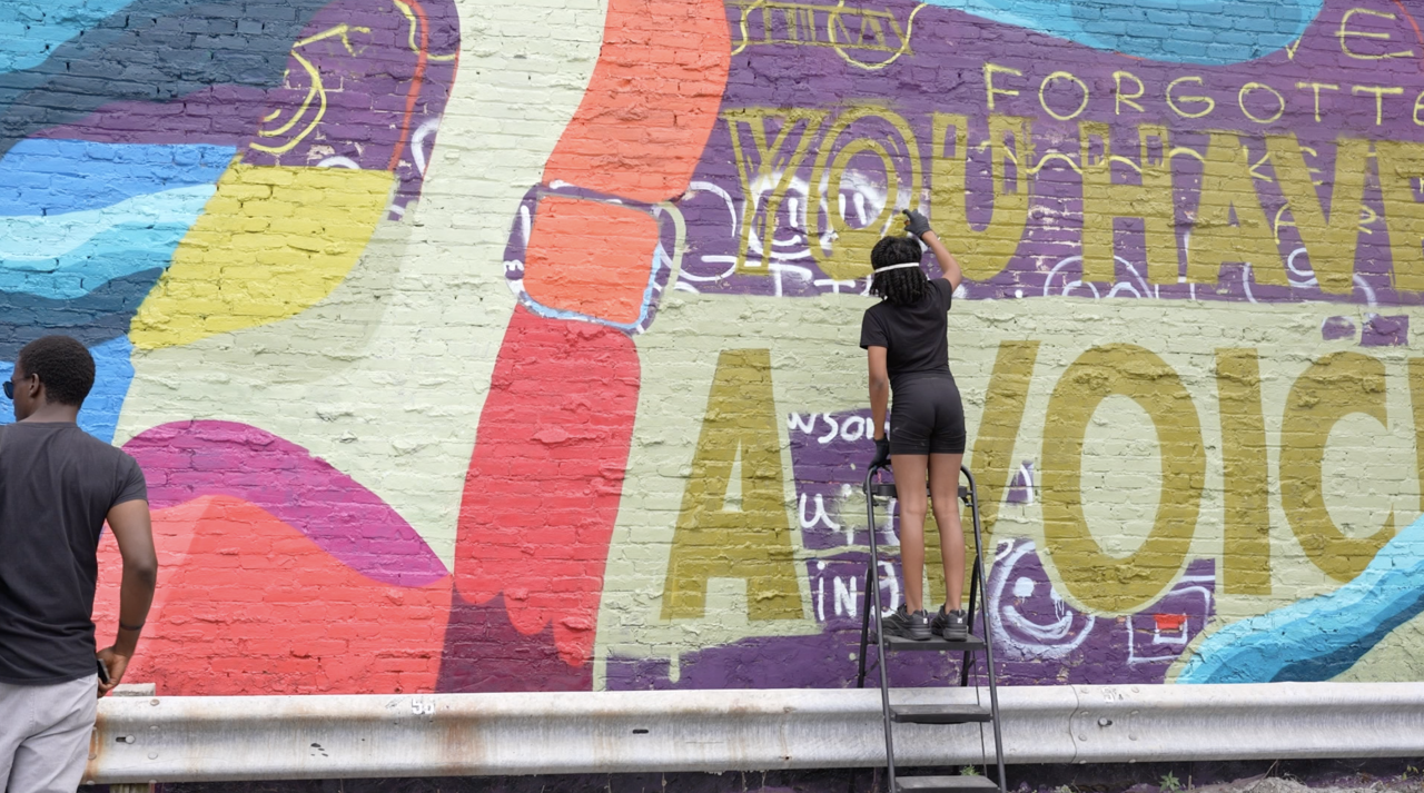 'You have a voice' is painted on the mural.