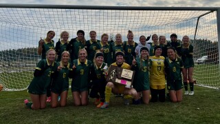 The Whitefish girls soccer team poses with the state championship trophy.