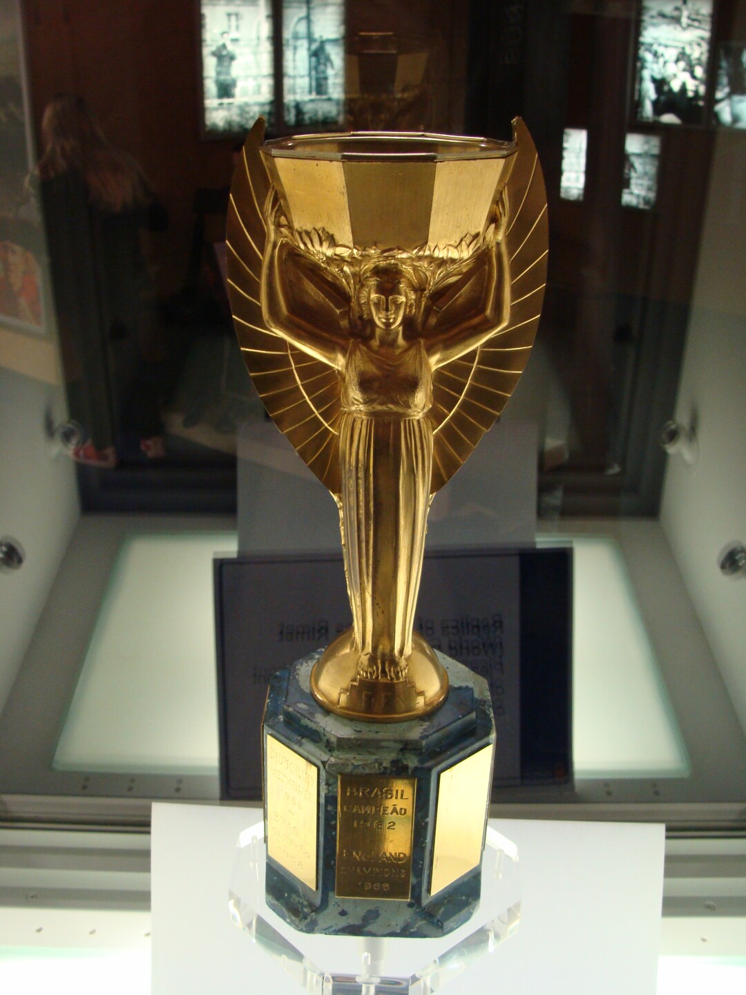 A replica of the Jules Rimet Trophy on display at the English National Football Museum. It sits in a glass case with a mirrored back.