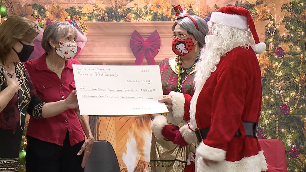Krewe-of-West-Tampa-presented-Tampa's-MacDonald-Training-Center-with-checks-WFTS-2.jpg