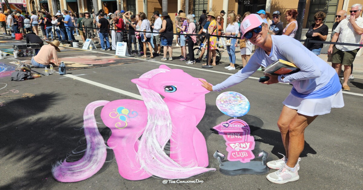 A woman draws a chalk mural of Pinkie Pie on the street