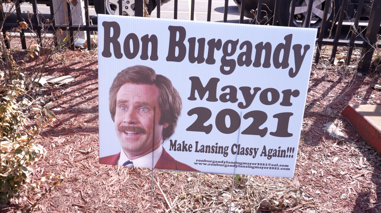 Signs for the new mayoral candidate are posted around Old Town