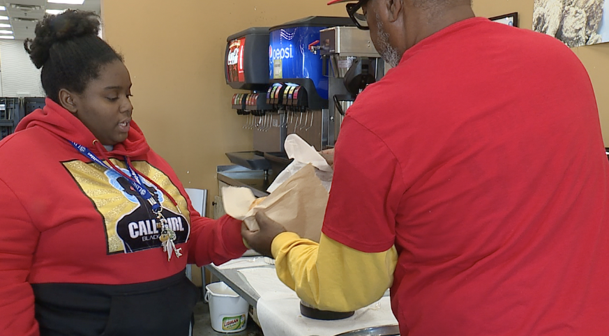 Community activist Pat Clarke hands out donuts