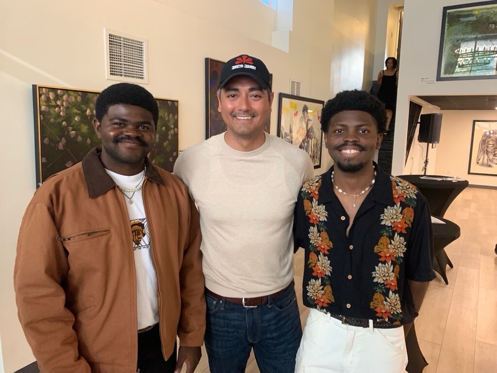 Romain Mayambi and his brother Gift with Mayor Aftab Pureval