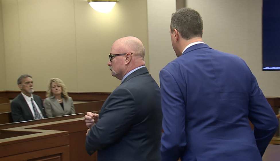 Detroit Fire Battalion Chief Thomas Suchora exiting the courtroom, passing by an onlooking Todd Richards and his wife