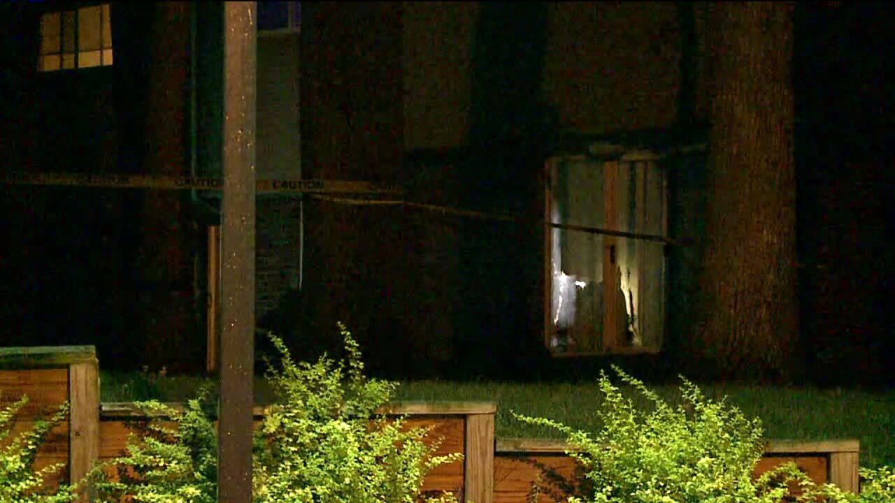 Crime scene tape around porch of apartment in Muskegon Heights