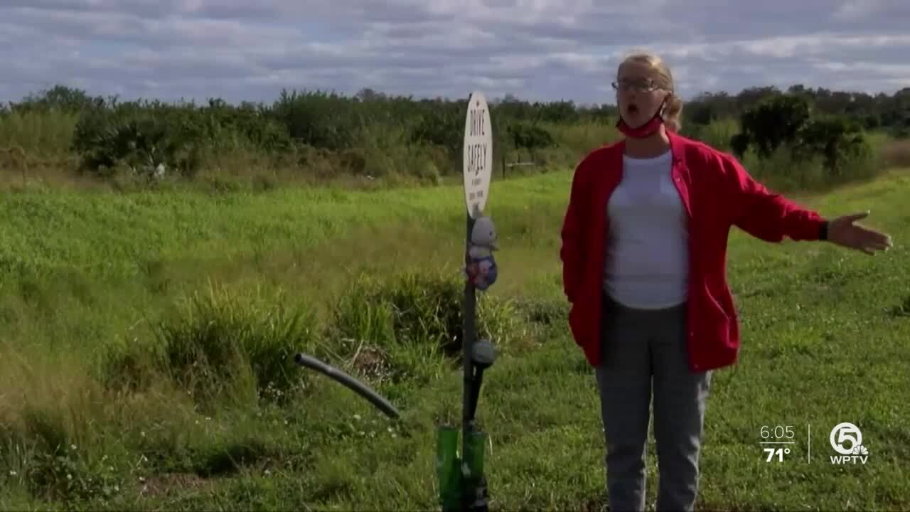 Dorothy Reynolds stands by roadside marker for Robert "Chino" Perone