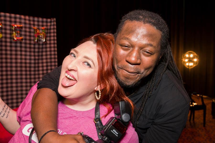 This candid photo shows two smiling people at a GLSEN Greater Cincinnati adult prom fundraiser.