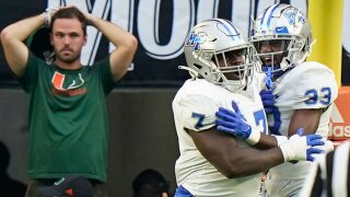 Middle Tennessee defensive tackle Zaylin Wood (7) celebrates with cornerback Decorian Patterson (33) after Wood intercepted the ball and scored during the first half of an NCAA college football game against Miami, Saturday, Sept. 24, 2022, in Miami Gardens, Fla.