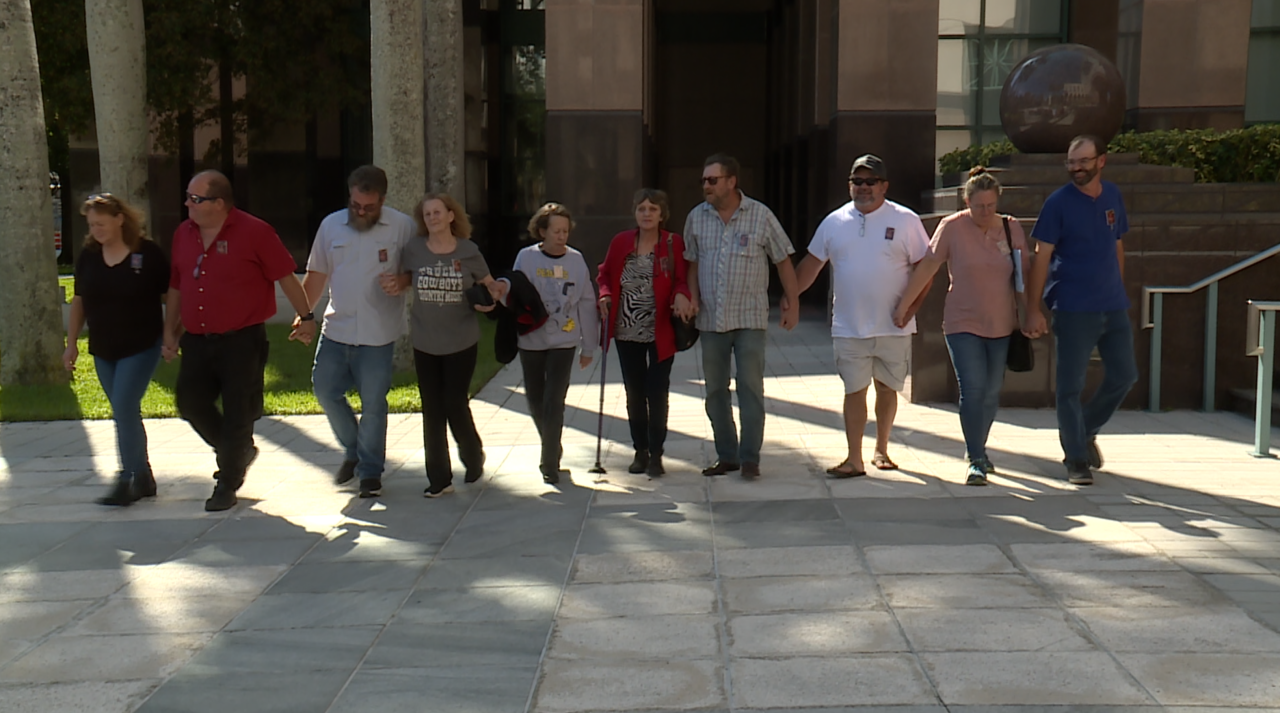 Family of Carla Lowe walks out of court holding hands, Nov. 14, 2022