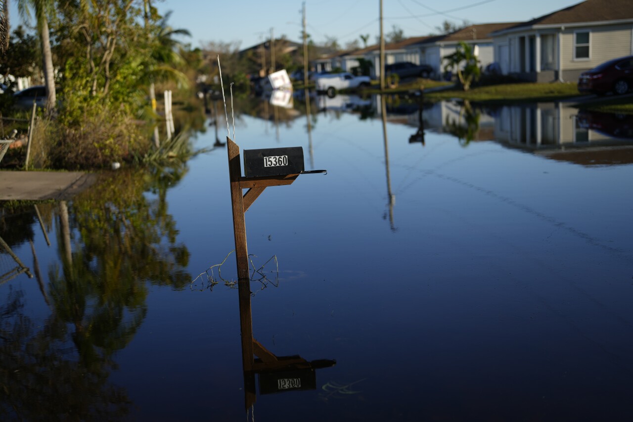 receding water still floods street in Harlem Heights neighborhood of Fort Myers after Hurricane Ian, Oct. 1, 2022