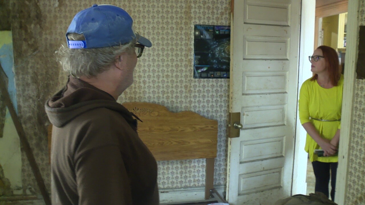 Ed Livernois shows News 5 reporter Michelle Jarboe a water-damaged bedroom at his house in Cleveland.