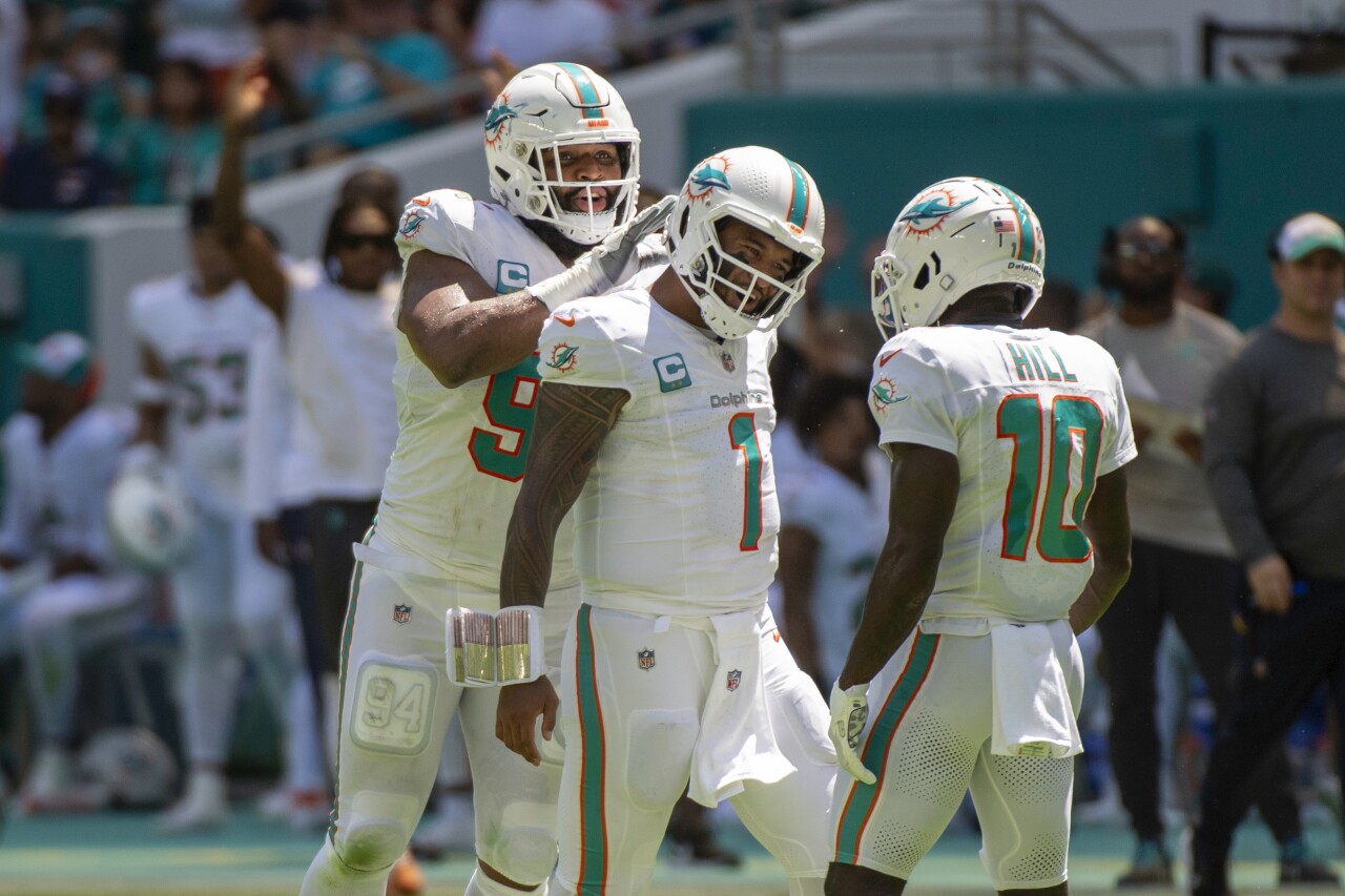 Miami Dolphins QB Tua Tagovailoa celebrates with receiver Tyreek Hill and defensive tackle Christian Wilkins after TD vs. Denver Broncos, Sept. 24, 2023