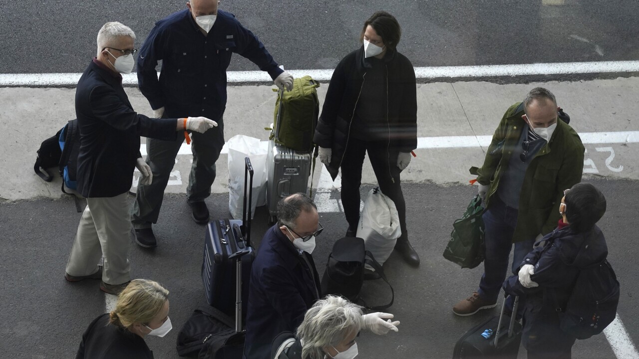 Members of a WHO team arrives in Wuhan in central China's Hubei province on Thursday, Jan. 14, 2021. The global team of researchers arrived Thursday in the Chinese city where the coronavirus pandemic was first detected to conduct a politically sensitive investigation into its origins amid uncertainty about whether Beijing might try to prevent embarrassing discoveries. (AP Photo/Ng Han Guan)