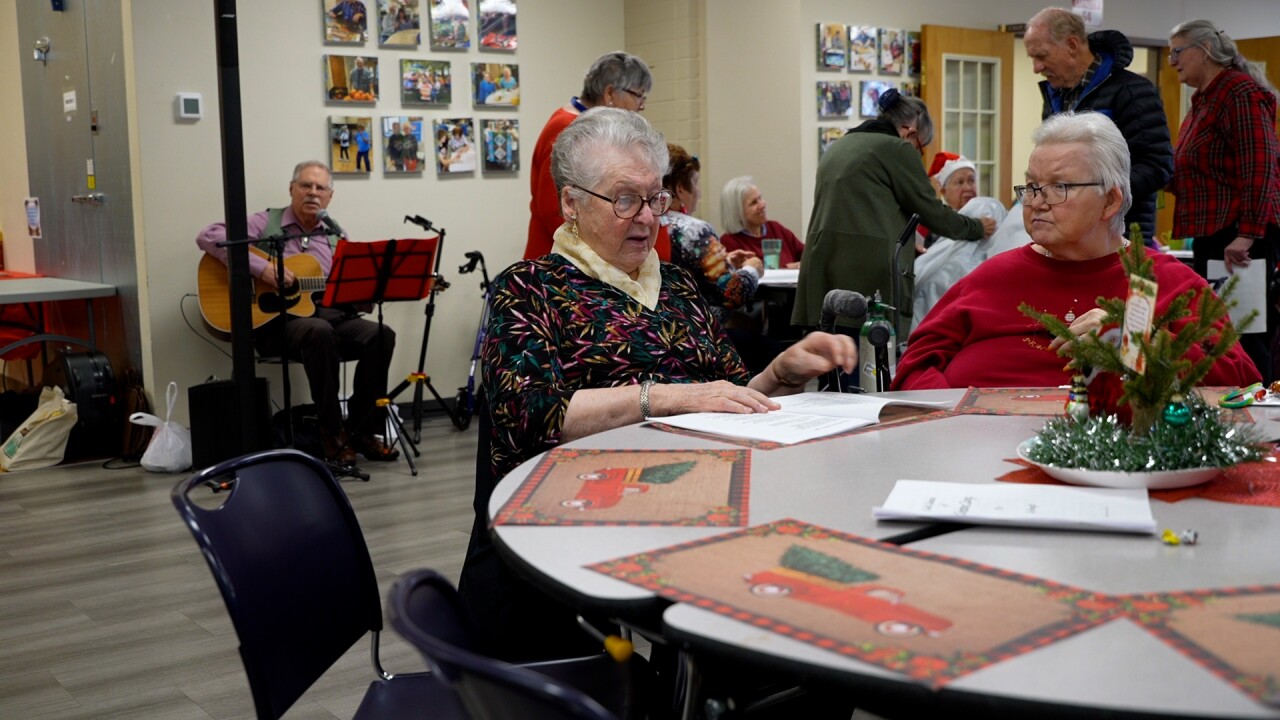 Women flipping thru carols