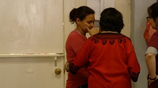 Iris, a mother from Honduras, weeps after speaking to reporters about being separated from her six-year-old son.