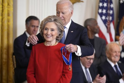 President Joe Biden, right, presents the Presidential Medal of Freedom, the Nation's highest civilian honor, to former Secretary of State Hillary Clinton