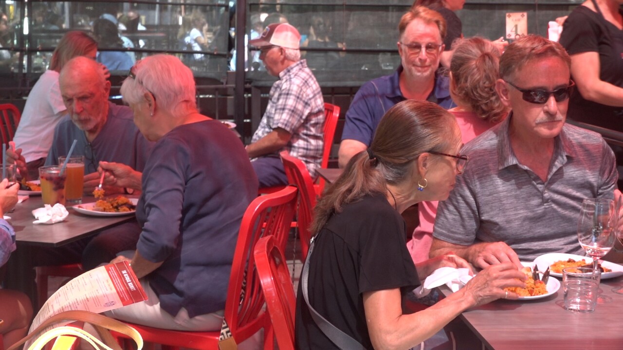 Customers enjoy their paella on the patio