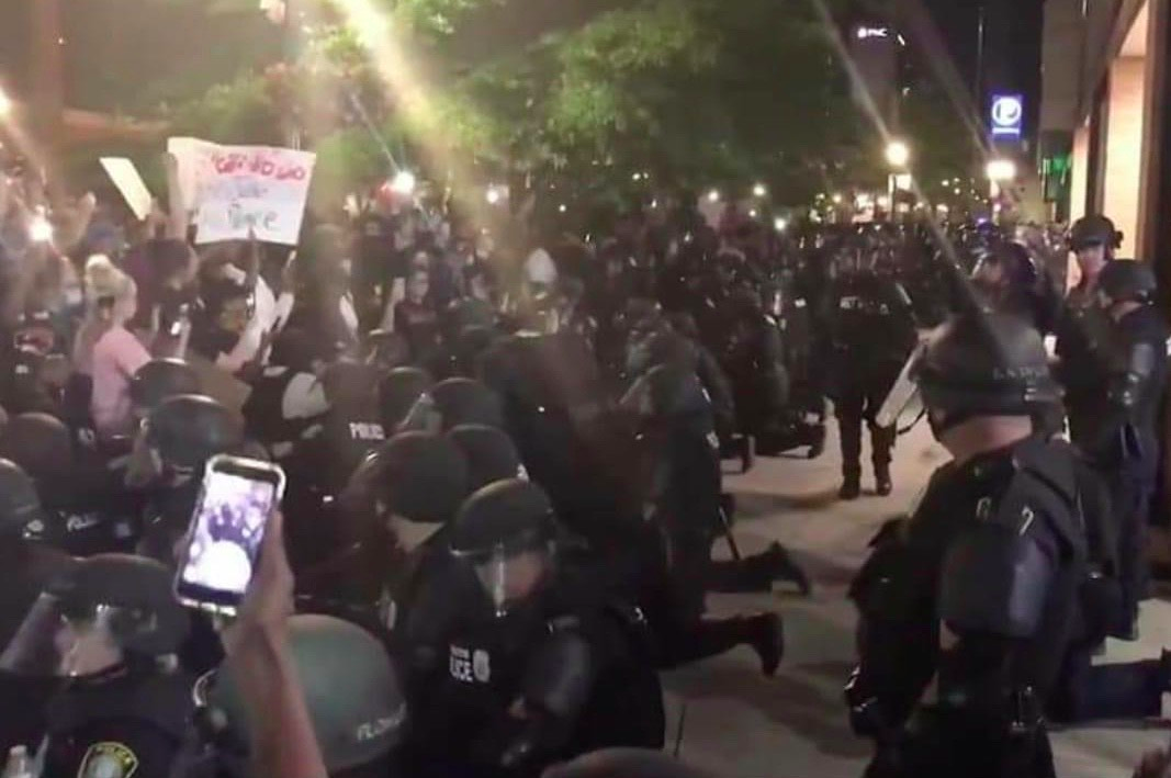 Police kneeling in Lexington.png