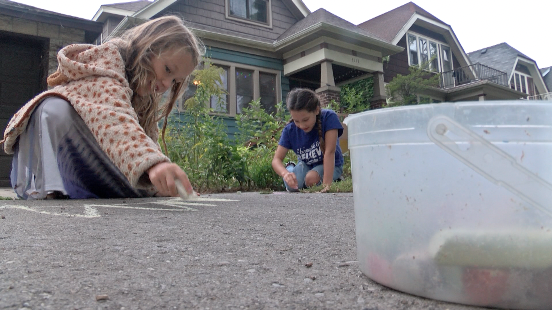 Girls doing chalk art for Mailman Mike