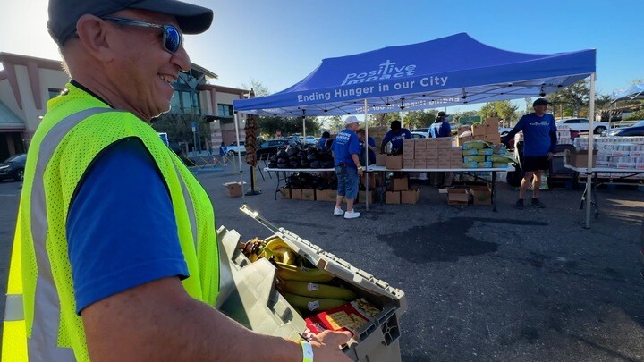 Volunteers help distribute free groceries at Tangerine Plaza in St. Pete