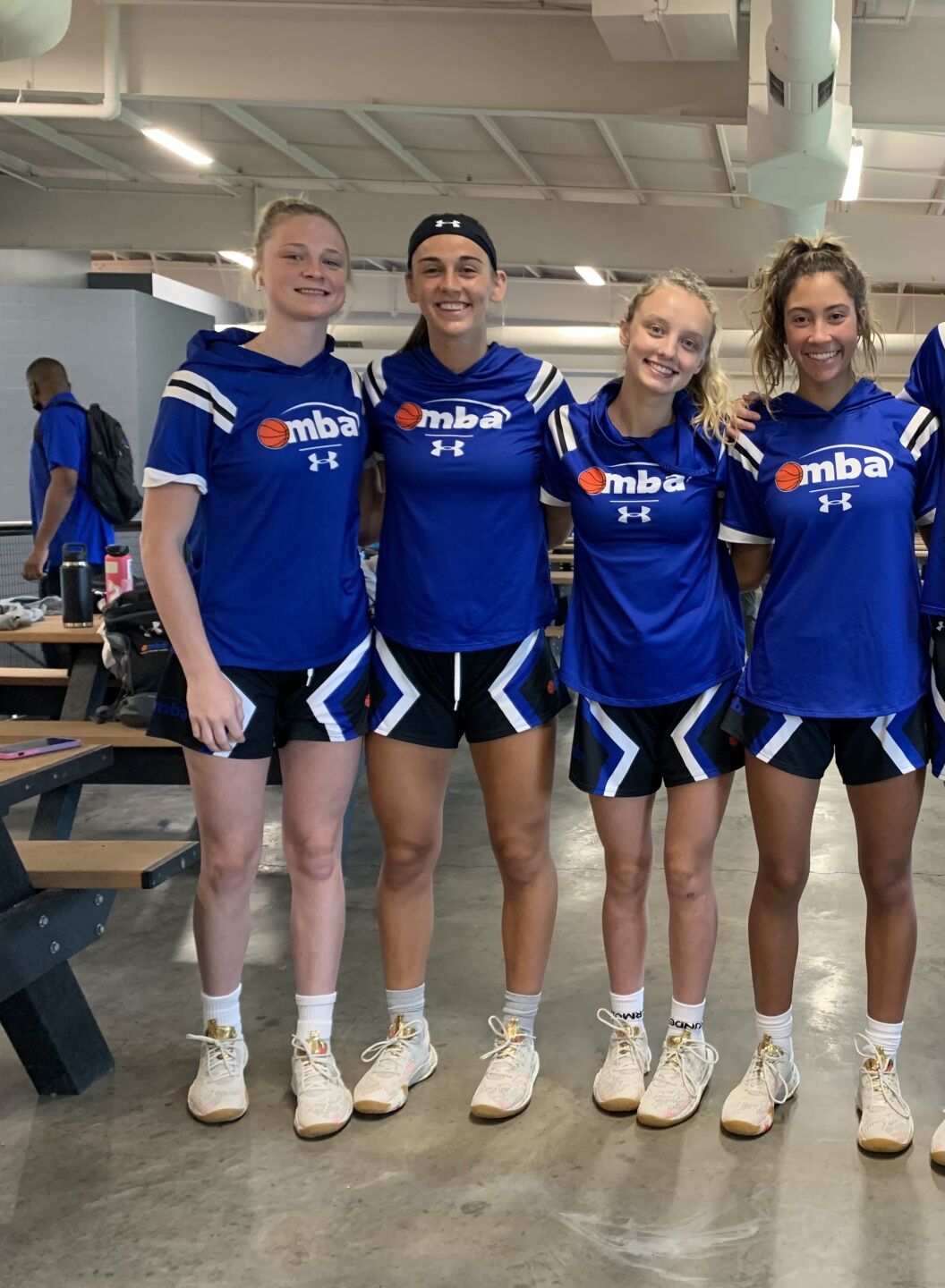 Four MBA players smile before a game