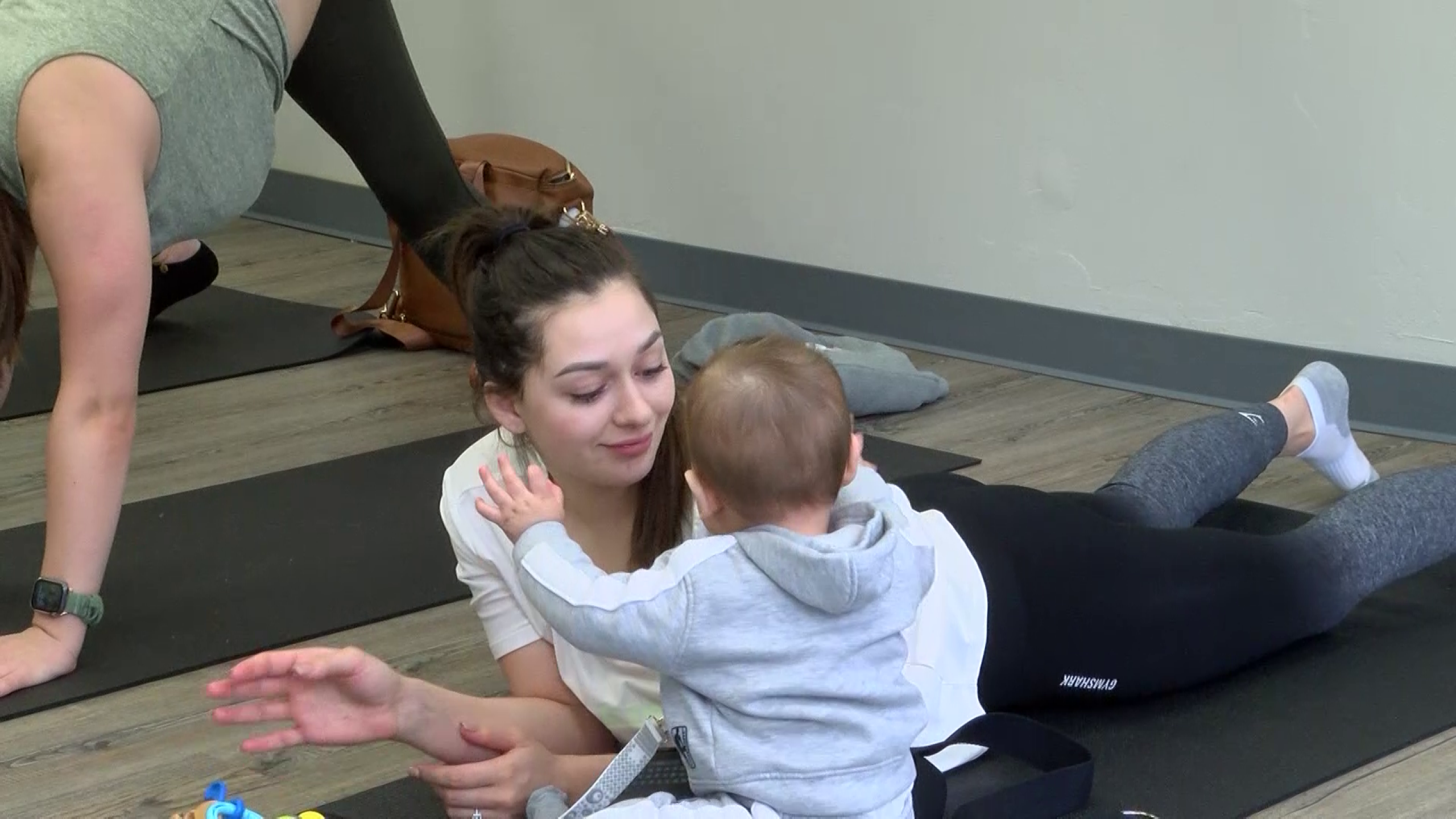 Parents enjoy 'Baby and Me' yoga class at Honey Hippo Play Café