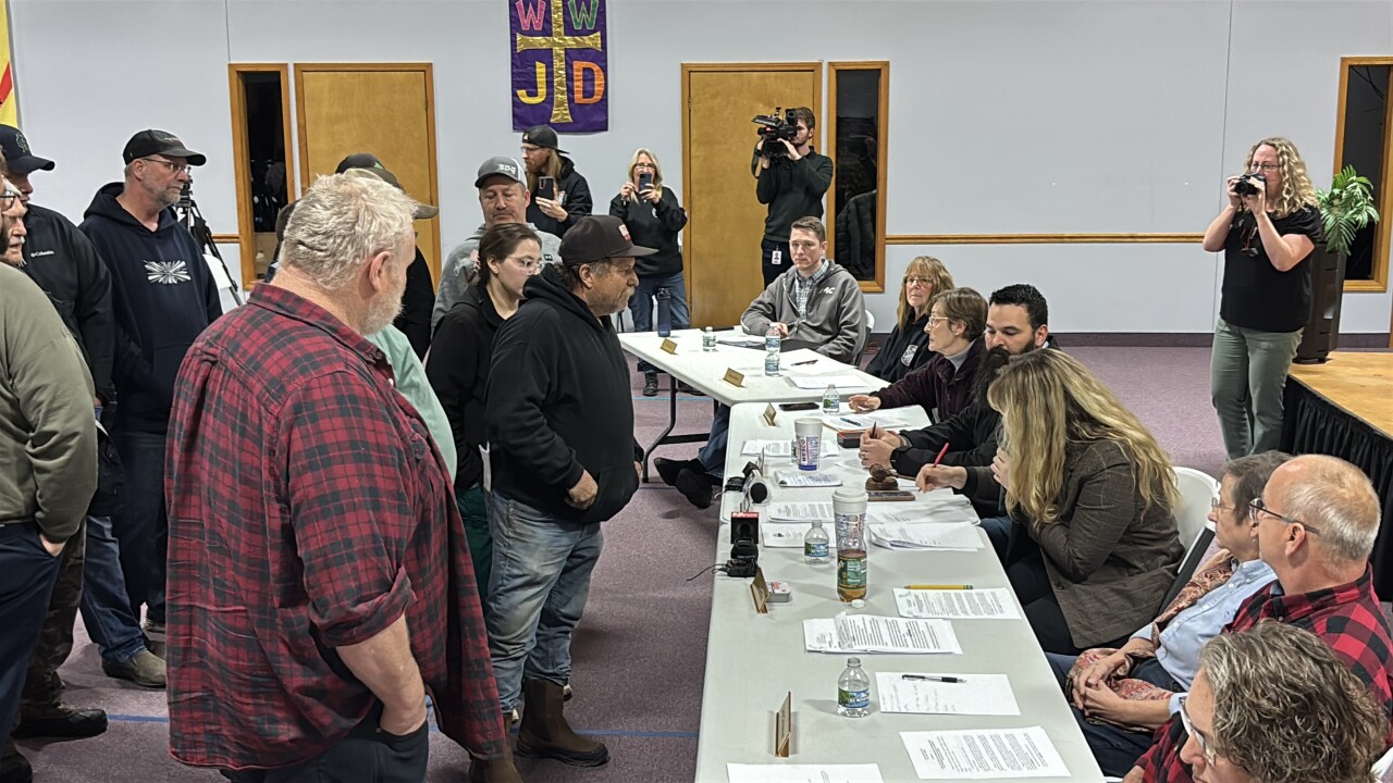 Sand Lake firefighters approach board table