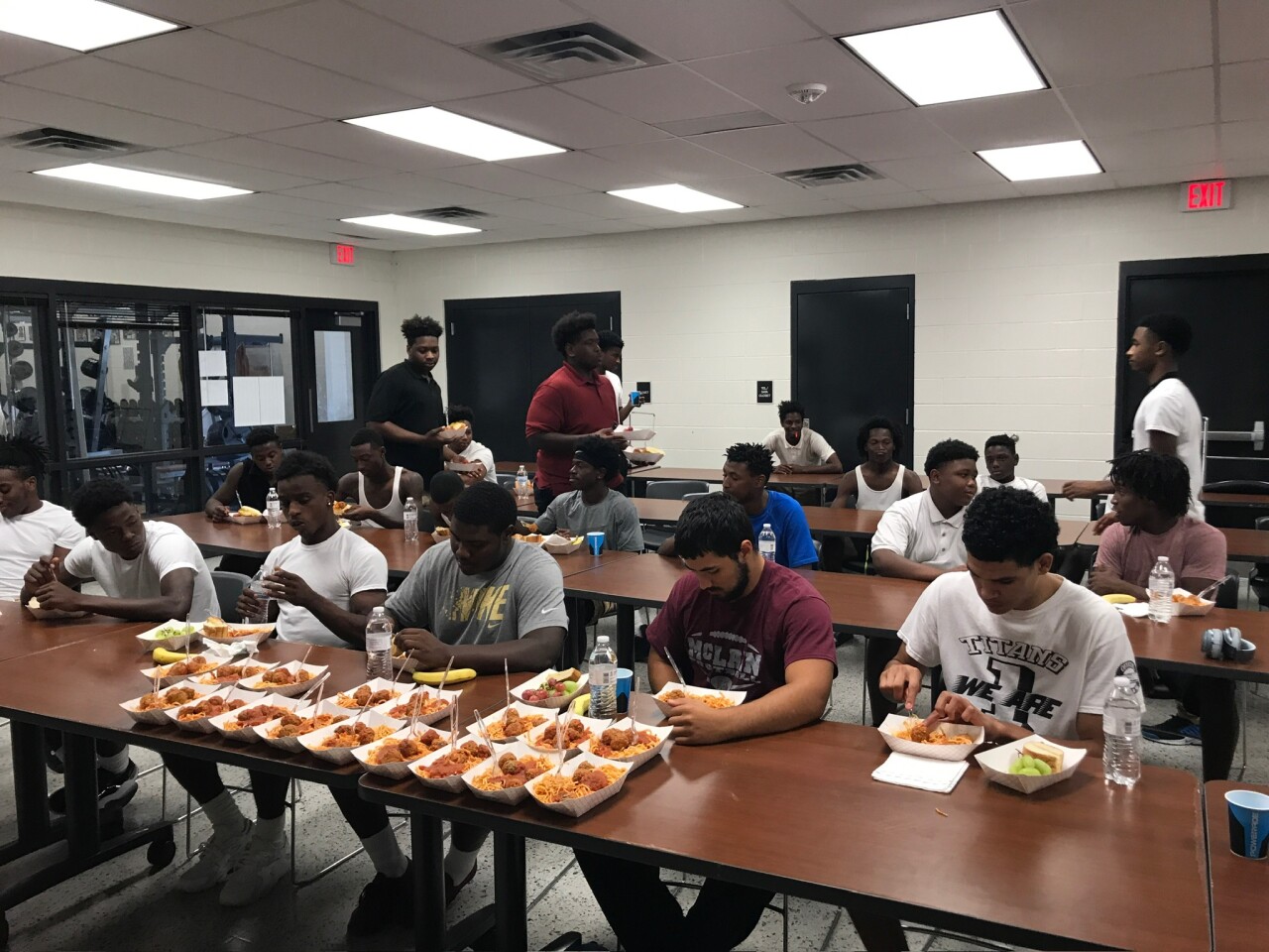 McLain High School Football Team eating spaghetti  