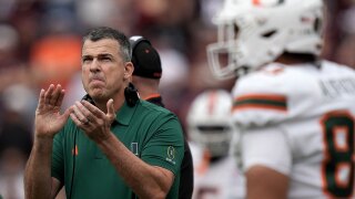 Miami head coach Mario Cristobal claps after his team, leaves the field for a time out against Texas A&M during the first quarter in the first round of the College Football Playoff Saturday, Dec. 20, 2025, in College Station, Texas. (AP Photo/Sam Craft)