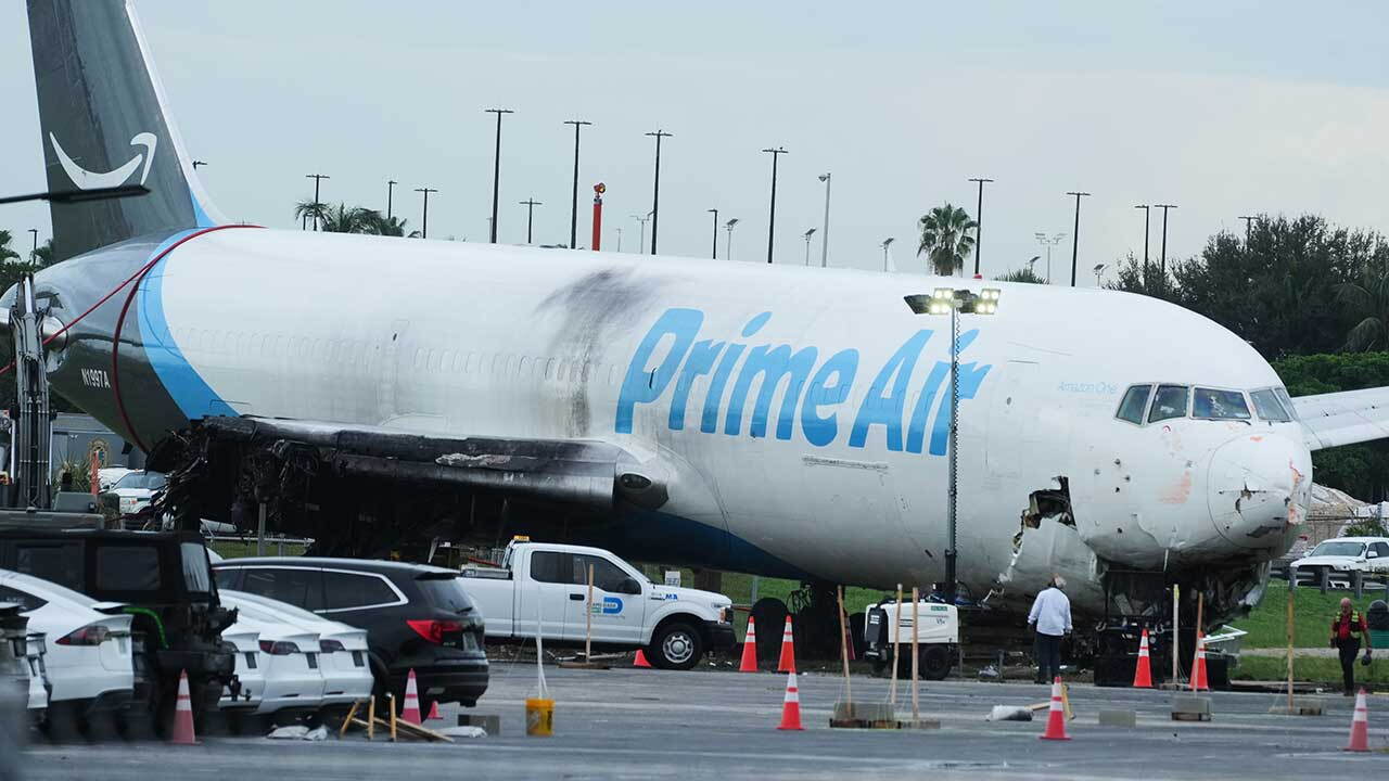 Workers inspect an Amazon cargo plane that overshot a runway four days ago at Miami International Airport, Thursday, Sept. 10, 2026, in Miami. 