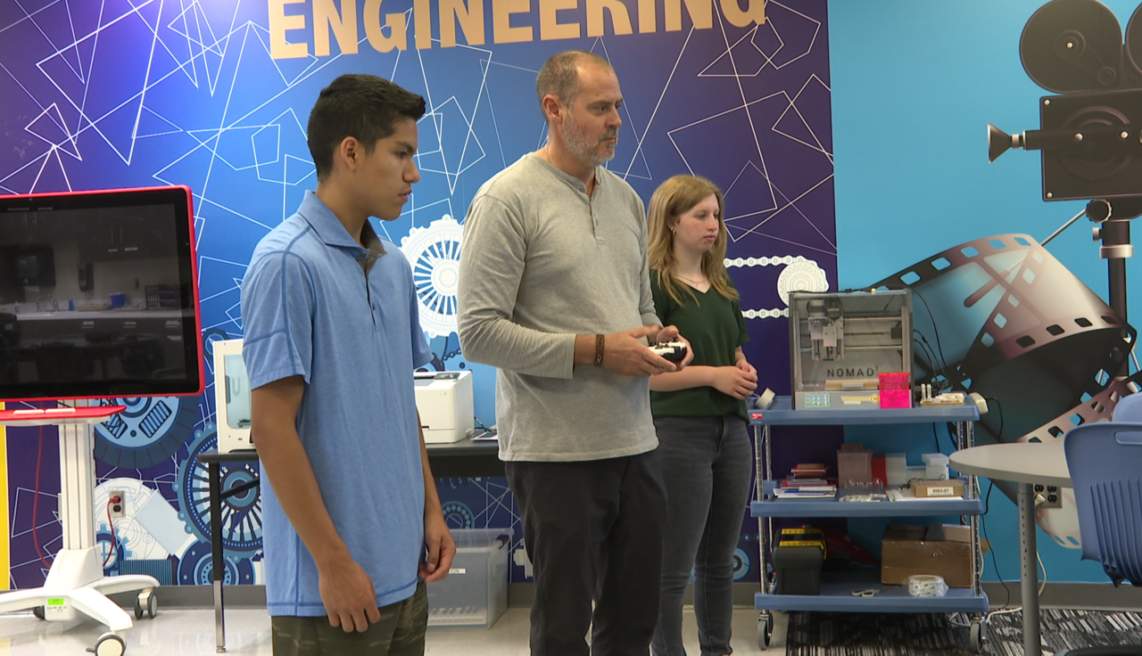 James Cox instructing students on how to fly a drone.