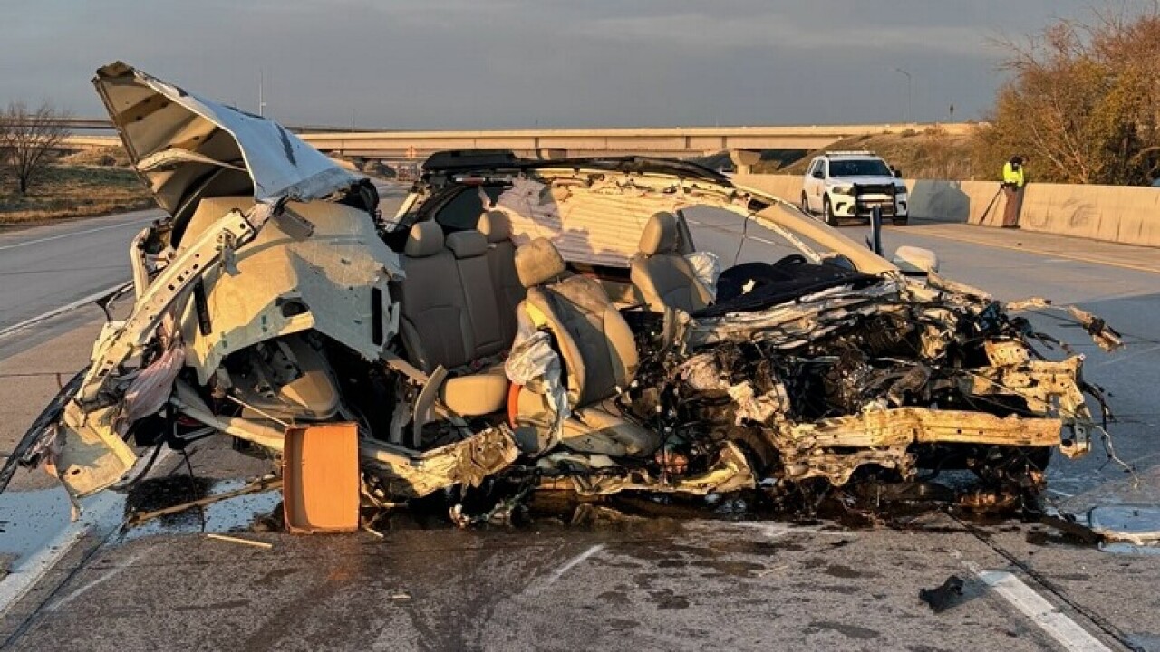 A photo from the scene released by Utah Highway Patrol. It's morning, and a vehicle sits on the road, utterly destroyed from the impact of the crash. The frame of the vehicle is a crumpled heap of metal, with the car's seats exposed to the elements.