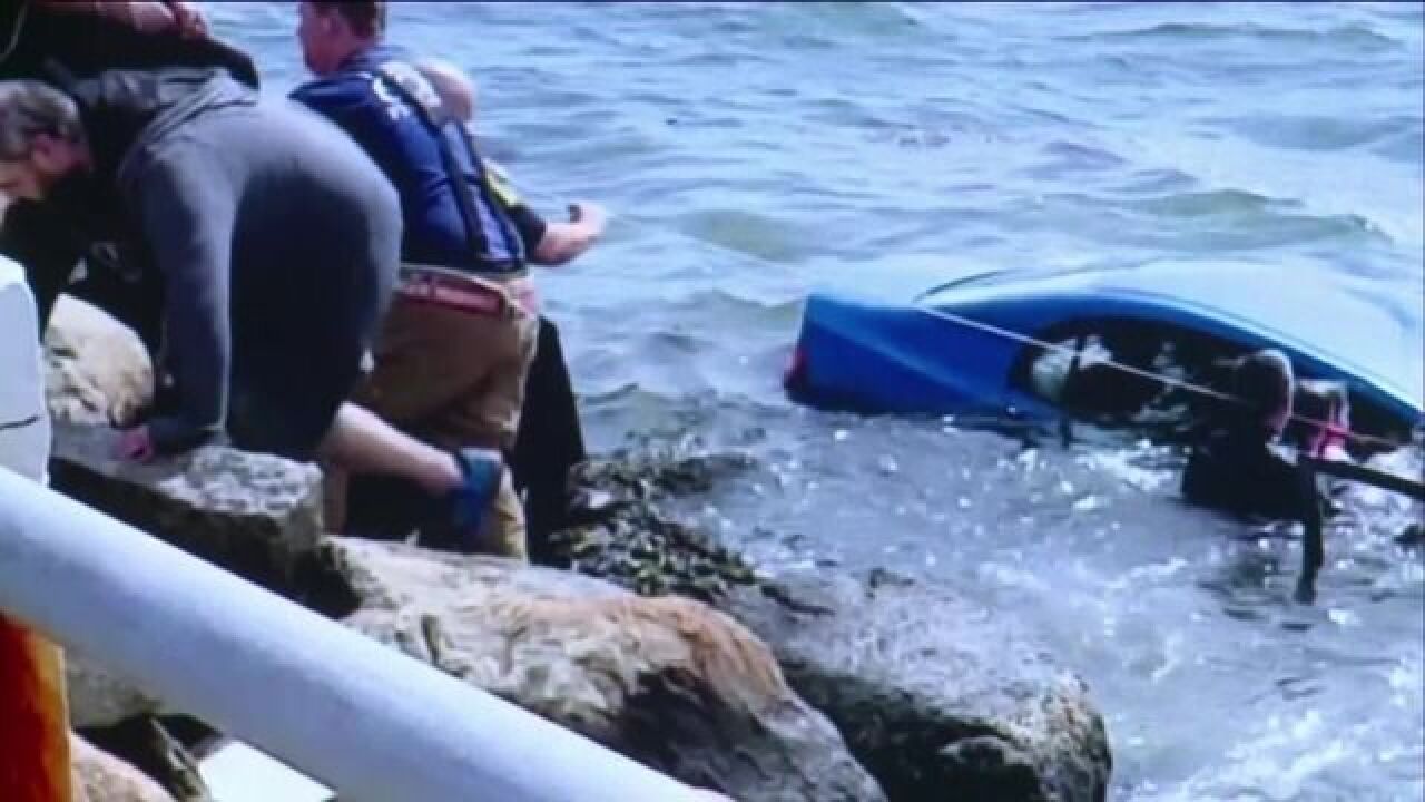WATCH: Woman pulled from sinking car
