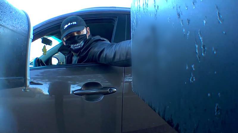 Masked man opens two mailboxes