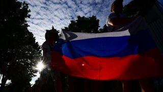 People hold a Russian flag