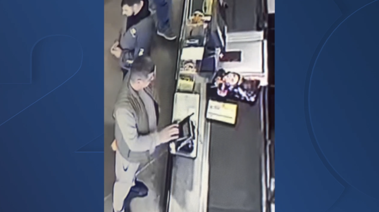 person putting skimmer on card reader